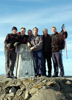 A successful Three Peaks Challenge team on the summit of Ben Nevis